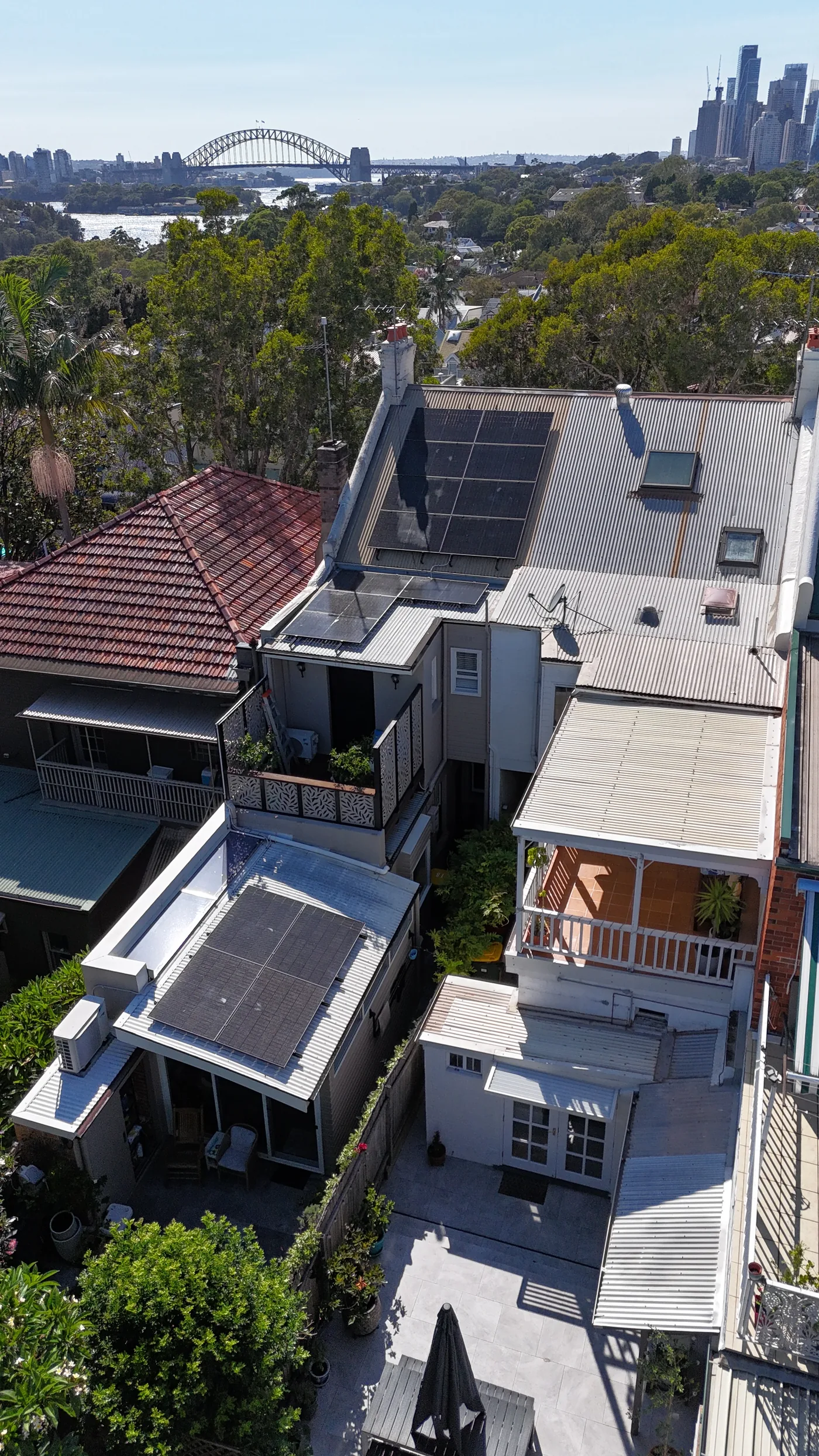 Solar panels on a heritage terrace roof with the Sydney Harbour Bridge behind