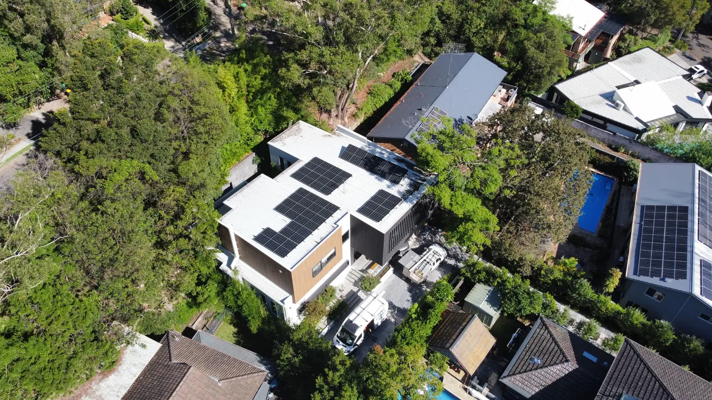 Panels across the roof of a bushland home with a pool